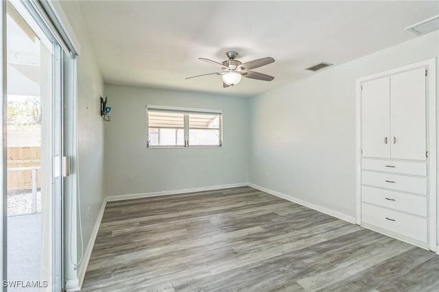 4330 S Canal Cir, North Fort Myers, FL 33903 - unfurnished bedroom featuring light wood-style floors, baseboards, and a ceiling fan