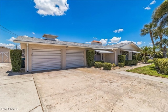 4330 S Canal Cir, North Fort Myers, FL 33903 - ranch-style house with driveway, a garage, and a chimney