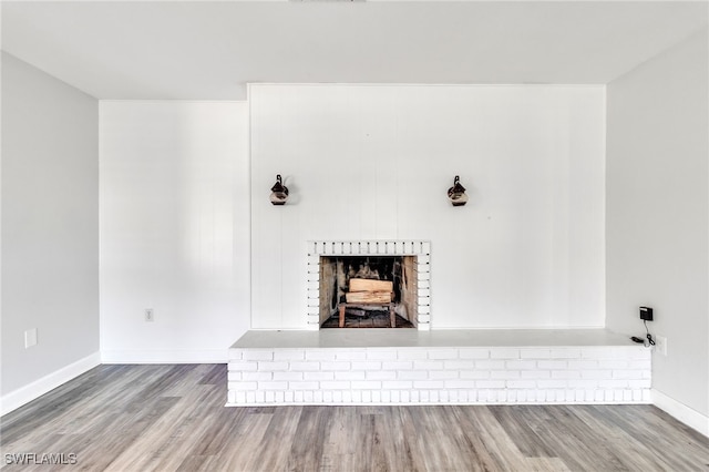 4330 S Canal Cir, North Fort Myers, FL 33903 - detailed view of a brick fireplace, wood finished floors, and baseboards