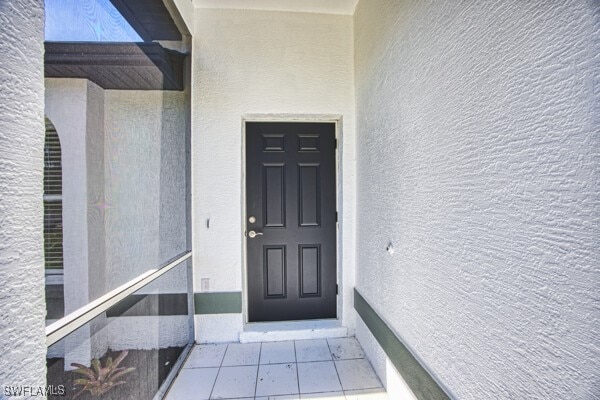 3815 Kittyhawk Dr, Fort Myers, FL 33905 - doorway to property with stucco siding