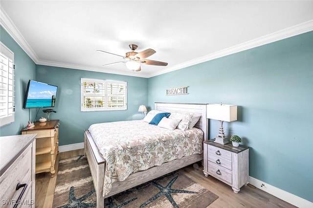 333 Harbour Dr Unit 201, Naples, FL 34103 - bedroom featuring ornamental molding, baseboards, wood finished floors, and multiple windows