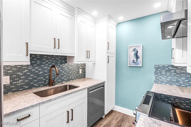 333 Harbour Dr Unit 201, Naples, FL 34103 - kitchen with appliances with stainless steel finishes, a sink, light wood-type flooring, white cabinets, and tasteful backsplash