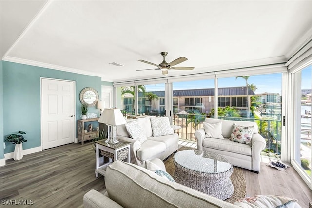 333 Harbour Dr Unit 201, Naples, FL 34103 - living area featuring a ceiling fan, wood finished floors, plenty of natural light, crown molding, and baseboards