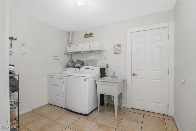 13031 9th St, Fort Myers, FL 33905 - laundry room featuring washer and clothes dryer, light tile patterned flooring, and baseboards