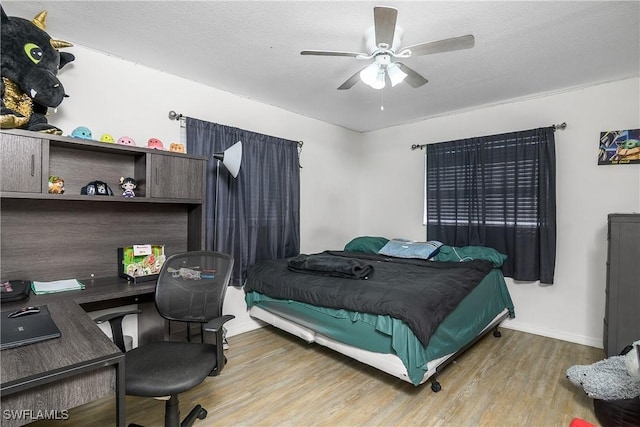 13031 9th St, Fort Myers, FL 33905 - bedroom with wood finished floors, a desk, baseboards, ceiling fan, and a textured ceiling
