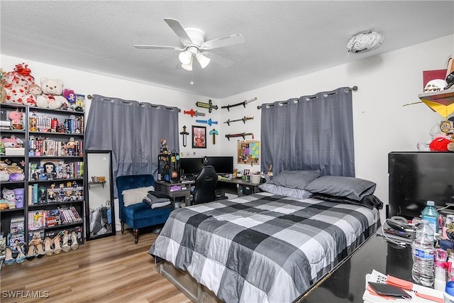 13031 9th St, Fort Myers, FL 33905 - bedroom with wood finished floors, a textured ceiling, and ceiling fan