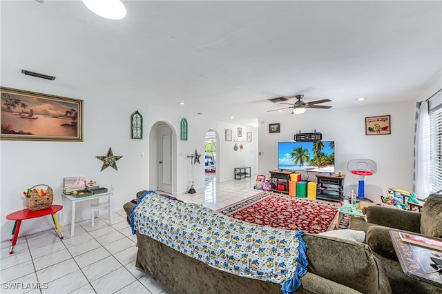 626 103rd Ave N, Naples, FL 34108 - living room featuring light tile patterned flooring, arched walkways, a ceiling fan, and recessed lighting