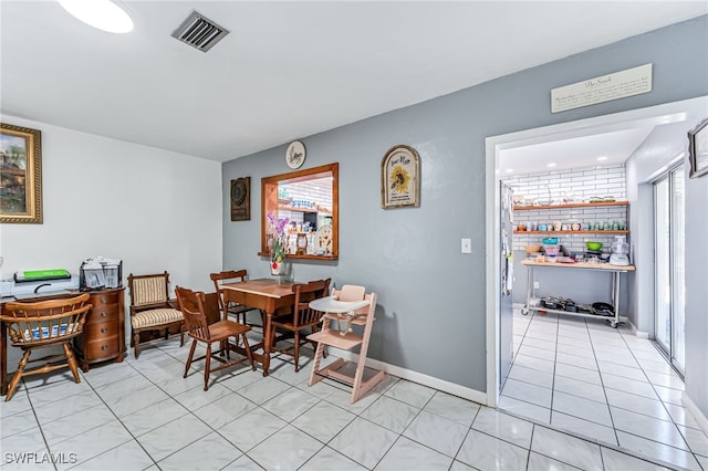 626 103rd Ave N, Naples, FL 34108 - dining room featuring light tile patterned floors and baseboards