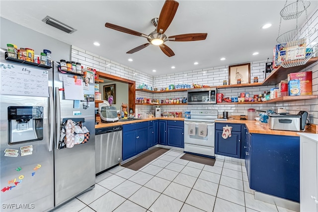 626 103rd Ave N, Naples, FL 34108 - kitchen with blue cabinets, stainless steel appliances, open shelves, a ceiling fan, and decorative backsplash