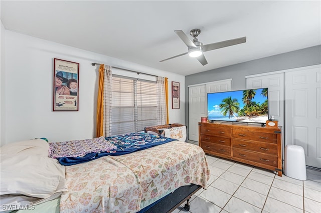 626 103rd Ave N, Naples, FL 34108 - bedroom with light tile patterned floors, a ceiling fan, and multiple closets