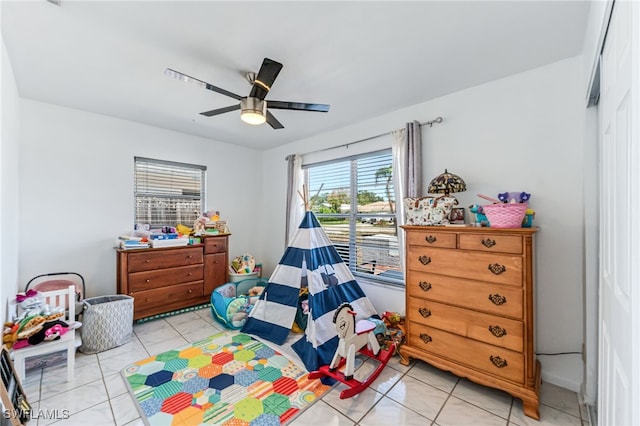 626 103rd Ave N, Naples, FL 34108 - bedroom with light tile patterned floors and ceiling fan
