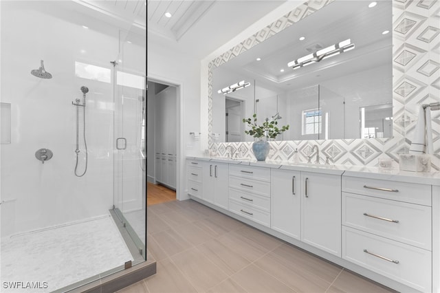 217 13th St S, Naples, FL 34102 - full bath featuring a shower stall, decorative backsplash, double vanity, recessed lighting, and a raised ceiling