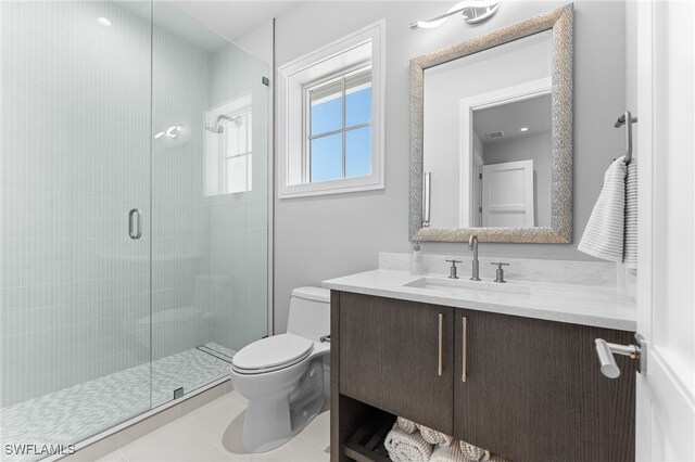 217 13th St S, Naples, FL 34102 - bathroom with toilet, a stall shower, vanity, and tile patterned flooring