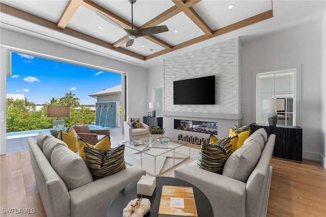 217 13th St S, Naples, FL 34102 - living area with coffered ceiling, wood finished floors, a glass covered fireplace, ceiling fan, and beam ceiling