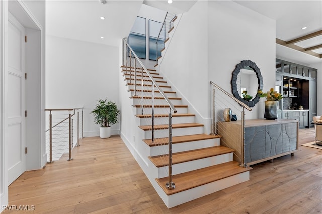 217 13th St S, Naples, FL 34102 - stairway with wood finished floors, recessed lighting, and baseboards