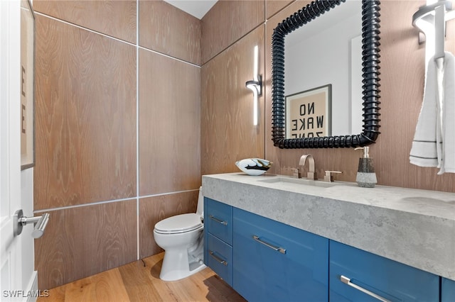 217 13th St S, Naples, FL 34102 - bathroom with toilet, vanity, and wood finished floors