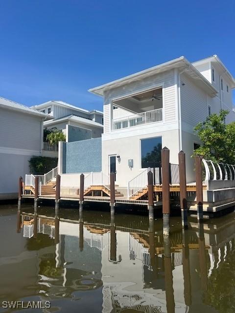 217 13th St S, Naples, FL 34102 - back of house with a balcony, a water view, and stairway