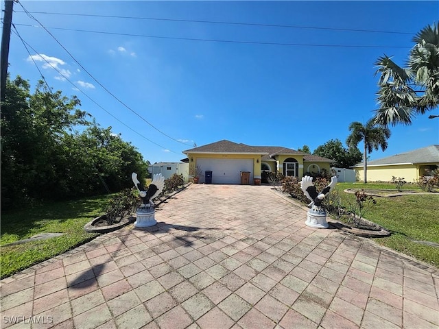 3903 1st St SW, Lehigh Acres, FL 33976 - view of front facade with an attached garage, a front lawn, and driveway