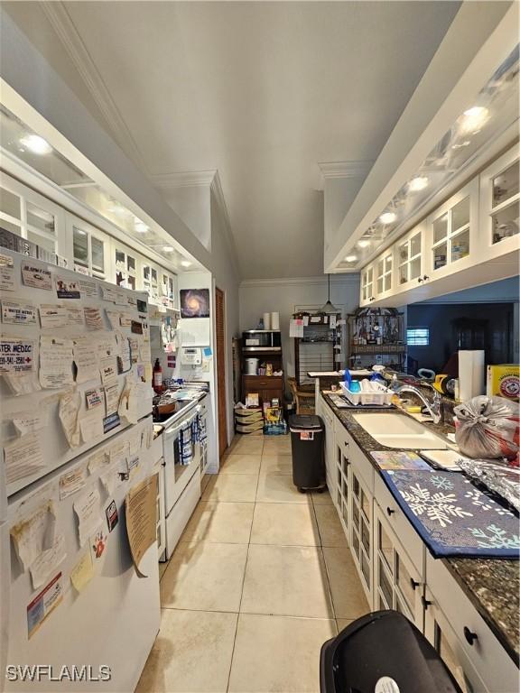 3903 1st St SW, Lehigh Acres, FL 33976 - kitchen featuring ornamental molding, a sink, white appliances, light tile patterned flooring, and glass insert cabinets