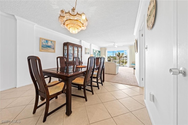 1977 Gulf Shore Blvd N Unit 302, Naples, FL 34102 - dining space with a textured ceiling, light tile patterned floors, ceiling fan, a chandelier, and crown molding