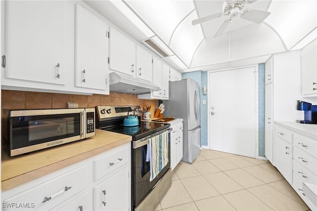 1977 Gulf Shore Blvd N Unit 302, Naples, FL 34102 - kitchen with appliances with stainless steel finishes, under cabinet range hood, light countertops, a ceiling fan, and light tile patterned floors
