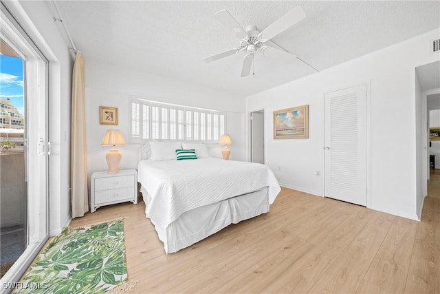 1977 Gulf Shore Blvd N Unit 302, Naples, FL 34102 - bedroom featuring light wood-type flooring, a textured ceiling, ceiling fan, and a closet