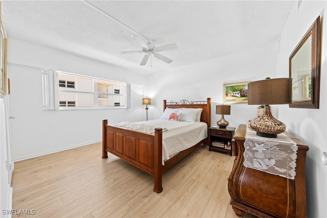 1977 Gulf Shore Blvd N Unit 302, Naples, FL 34102 - bedroom featuring light wood-type flooring and ceiling fan
