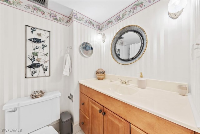 1977 Gulf Shore Blvd N Unit 302, Naples, FL 34102 - bathroom with wallpapered walls, toilet, and vanity