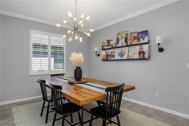 17326 Ashcomb Way, Estero, FL 33928 - dining room with a chandelier, wood finished floors, baseboards, and ornamental molding
