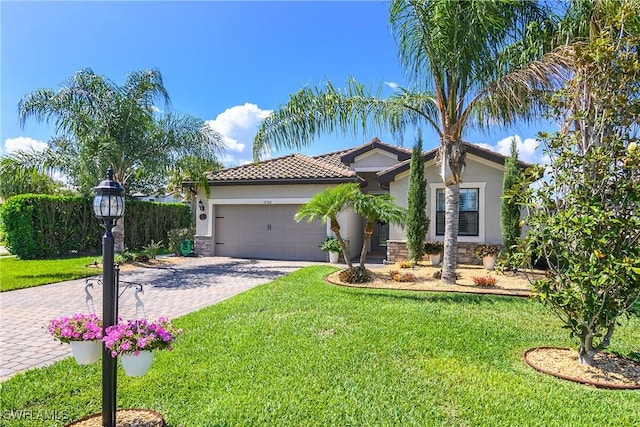 17326 Ashcomb Way, Estero, FL 33928 - view of front facade with stucco siding, decorative driveway, an attached garage, and a front lawn