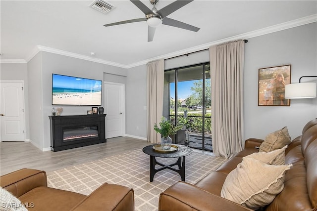 17326 Ashcomb Way, Estero, FL 33928 - living area with ornamental molding, baseboards, wood finished floors, ceiling fan, and a glass covered fireplace