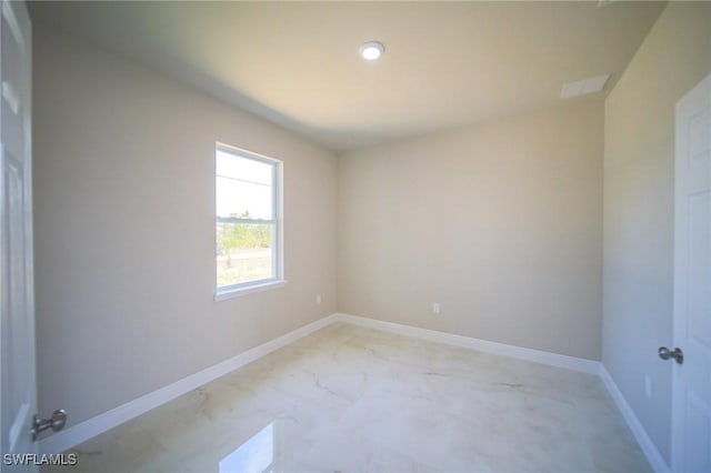 3711 6th St W, Lehigh Acres, FL 33971 - empty room featuring light marble finish floors and baseboards