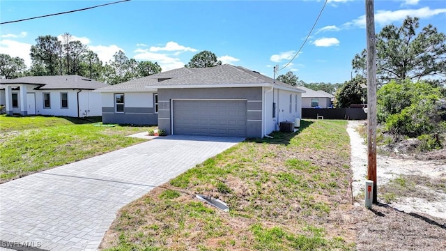 3711 6th St W, Lehigh Acres, FL 33971 - ranch-style home featuring an attached garage, decorative driveway, stucco siding, and central air condition unit