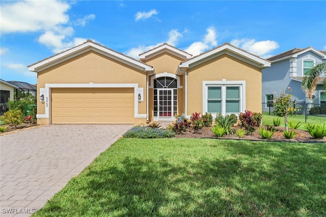 2642 Orange Grove Trl, Naples, FL 34120 - ranch-style home with stucco siding, an attached garage, and decorative driveway