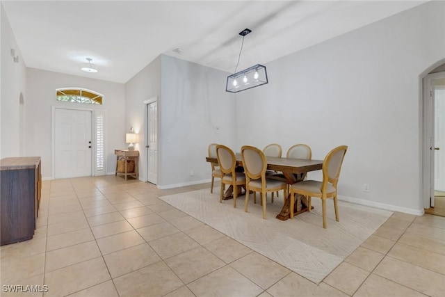 2642 Orange Grove Trl, Naples, FL 34120 - dining area featuring light tile patterned floors, arched walkways, and baseboards