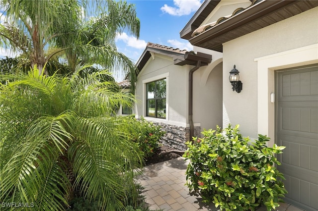 19694 Deming Ln, Estero, FL 33928 - view of exterior entry featuring stucco siding and stone siding