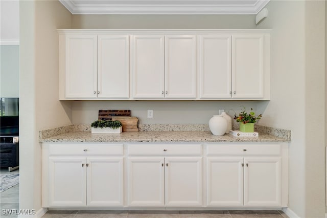 19694 Deming Ln, Estero, FL 33928 - kitchen with white cabinetry, light stone countertops, and crown molding