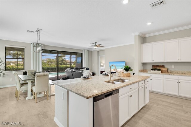 19694 Deming Ln, Estero, FL 33928 - kitchen with stainless steel dishwasher, a center island with sink, light stone counters, white cabinetry, and pendant lighting
