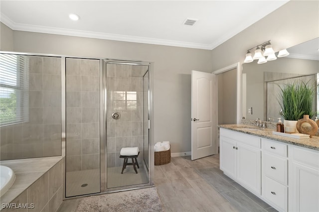 19694 Deming Ln, Estero, FL 33928 - bathroom with double vanity, a shower stall, a garden tub, and ornamental molding