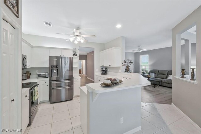 1340 Charleston Square Dr Unit 101, Naples, FL 34110 - kitchen featuring appliances with stainless steel finishes, a ceiling fan, light tile patterned floors, light countertops, and recessed lighting