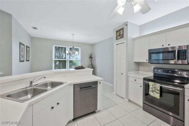 1340 Charleston Square Dr Unit 101, Naples, FL 34110 - kitchen with stainless steel appliances, a sink, light countertops, and white cabinets