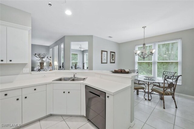 1340 Charleston Square Dr Unit 101, Naples, FL 34110 - kitchen featuring stainless steel dishwasher, a sink, a peninsula, light tile patterned floors, and recessed lighting