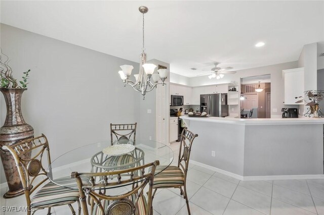 1340 Charleston Square Dr Unit 101, Naples, FL 34110 - dining area with ceiling fan, a chandelier, light tile patterned flooring, and baseboards