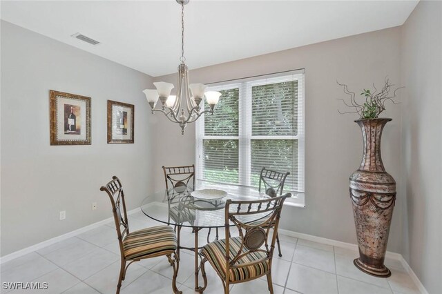 1340 Charleston Square Dr Unit 101, Naples, FL 34110 - dining area with a chandelier, baseboards, and light tile patterned floors