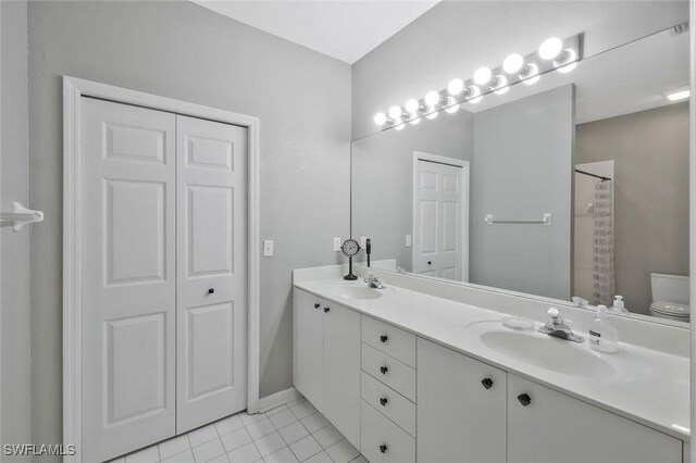 1340 Charleston Square Dr Unit 101, Naples, FL 34110 - bathroom featuring double vanity, tile patterned flooring, toilet, curtained shower, and baseboards