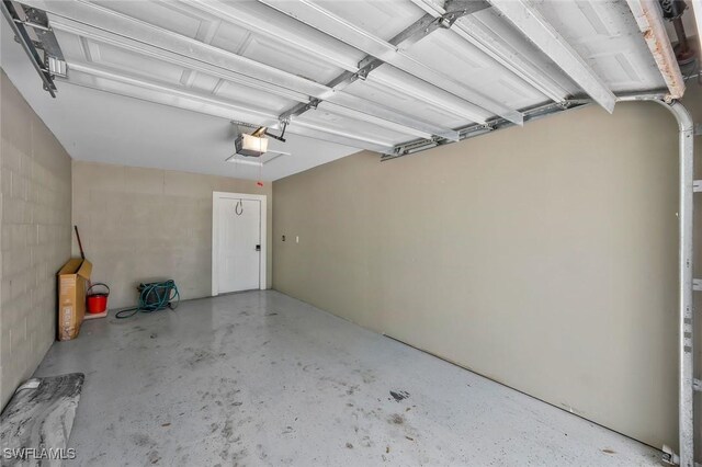 1340 Charleston Square Dr Unit 101, Naples, FL 34110 - garage featuring a garage door opener