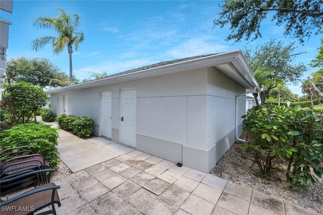 1340 Charleston Square Dr Unit 101, Naples, FL 34110 - view of side of home featuring a patio