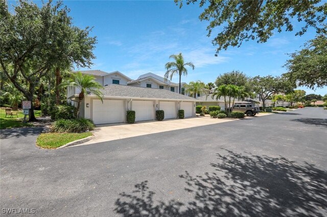 1340 Charleston Square Dr Unit 101, Naples, FL 34110 - view of front of property with stucco siding and a garage