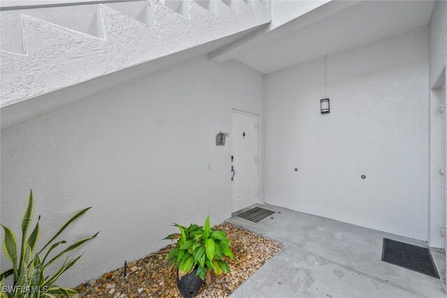 1340 Charleston Square Dr Unit 101, Naples, FL 34110 - doorway to property with stucco siding