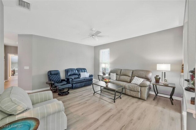 1340 Charleston Square Dr Unit 101, Naples, FL 34110 - living room featuring a ceiling fan, wood finished floors, and baseboards